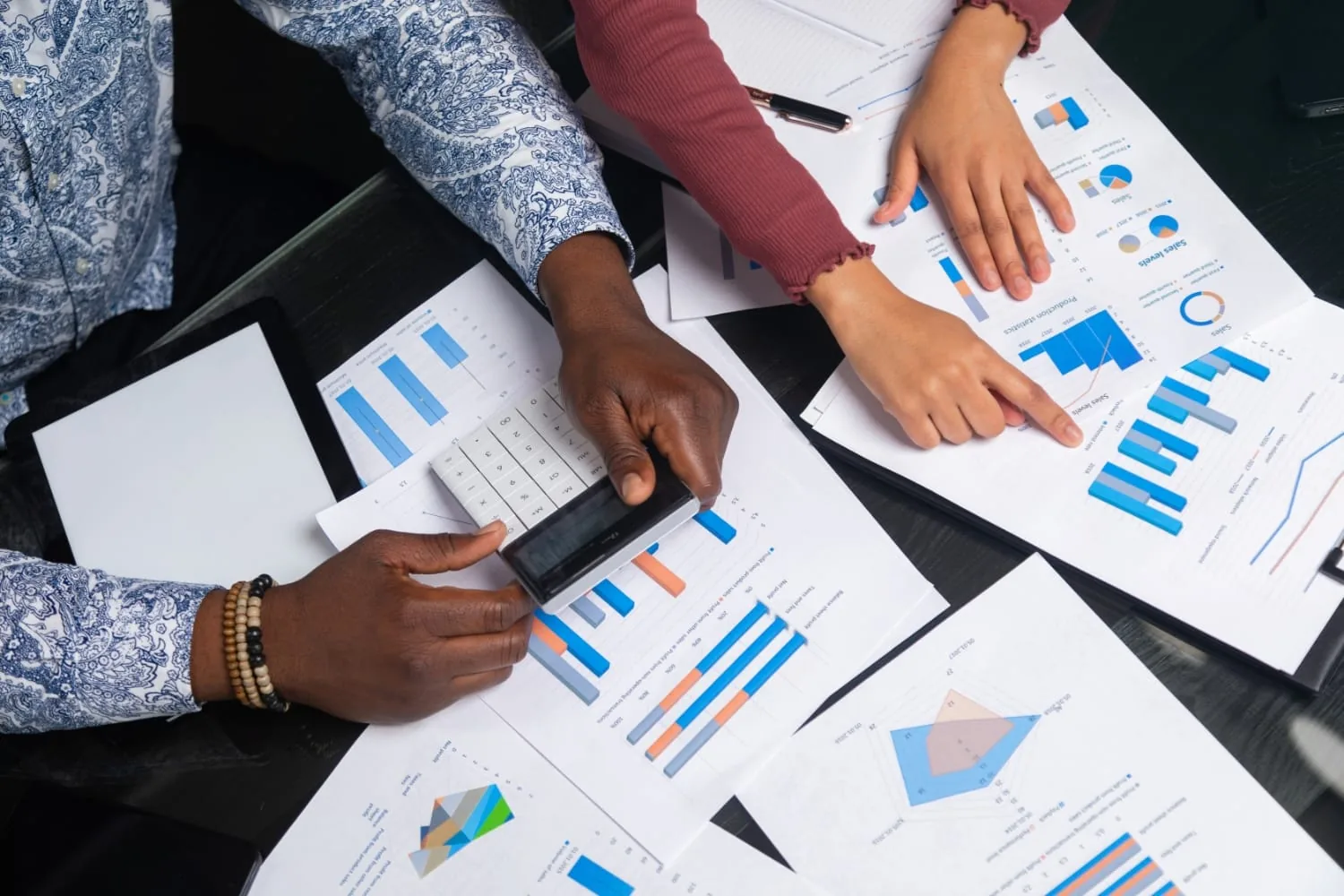 Professionals reviewing accounting reports and calculations